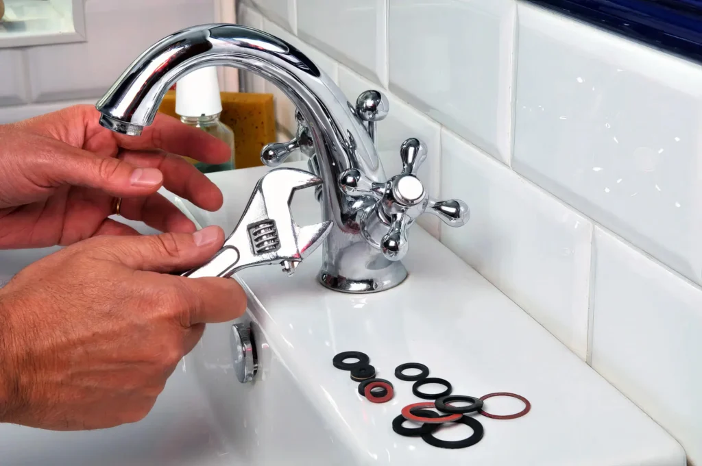 Plumber performing maintenance on a bathroom faucet in Salinas