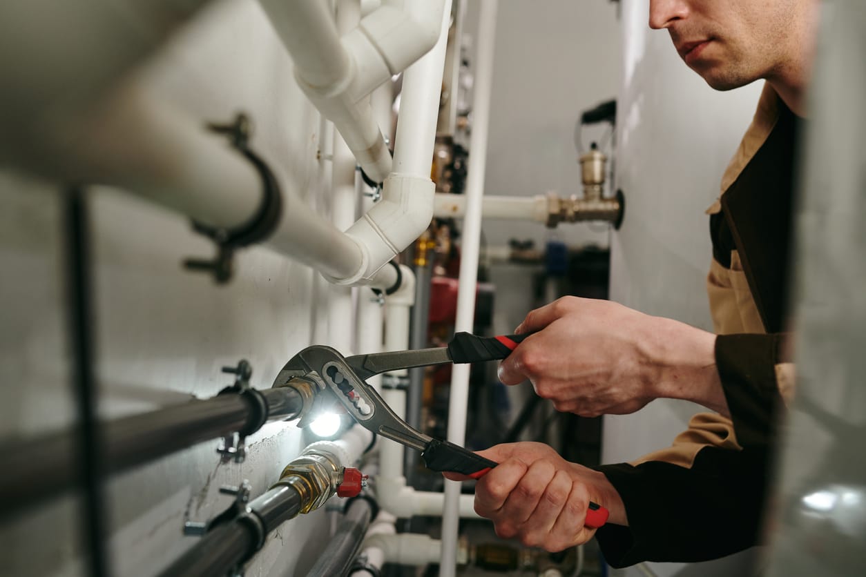 Plumbers maintaining commercial plumbing pipes in Salinas