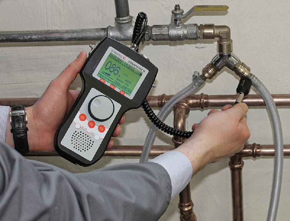 Plumber testing pipes with electronic leak detection equipment in Salinas