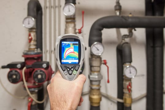 Plumber using a thermal imaging camera to inspect pipes in Salinas