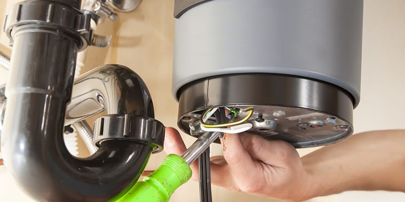 Technician repairing the heating element of a water heater in Salinas