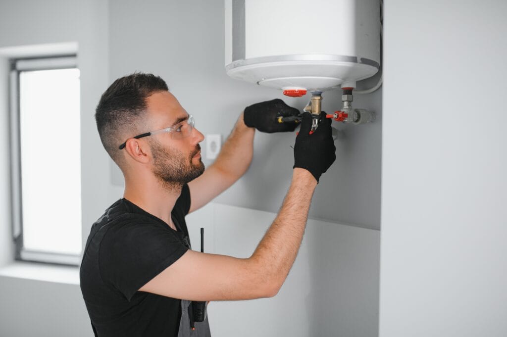 Technician performing water heater maintenance in Salinas