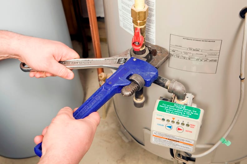 Plumber repairing a water heater valve in Salinas